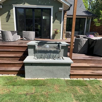 Bluestone fountain built against a backyard deck