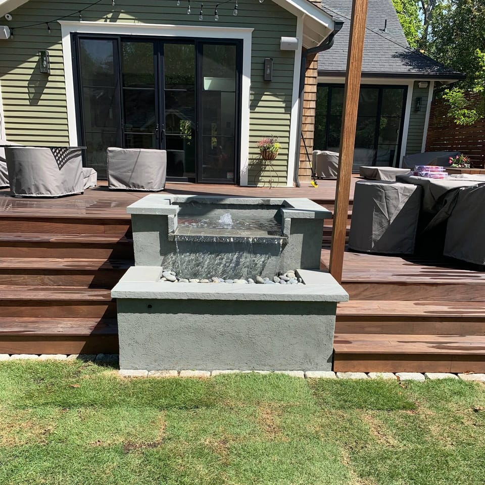 Bluestone fountain built against a backyard deck